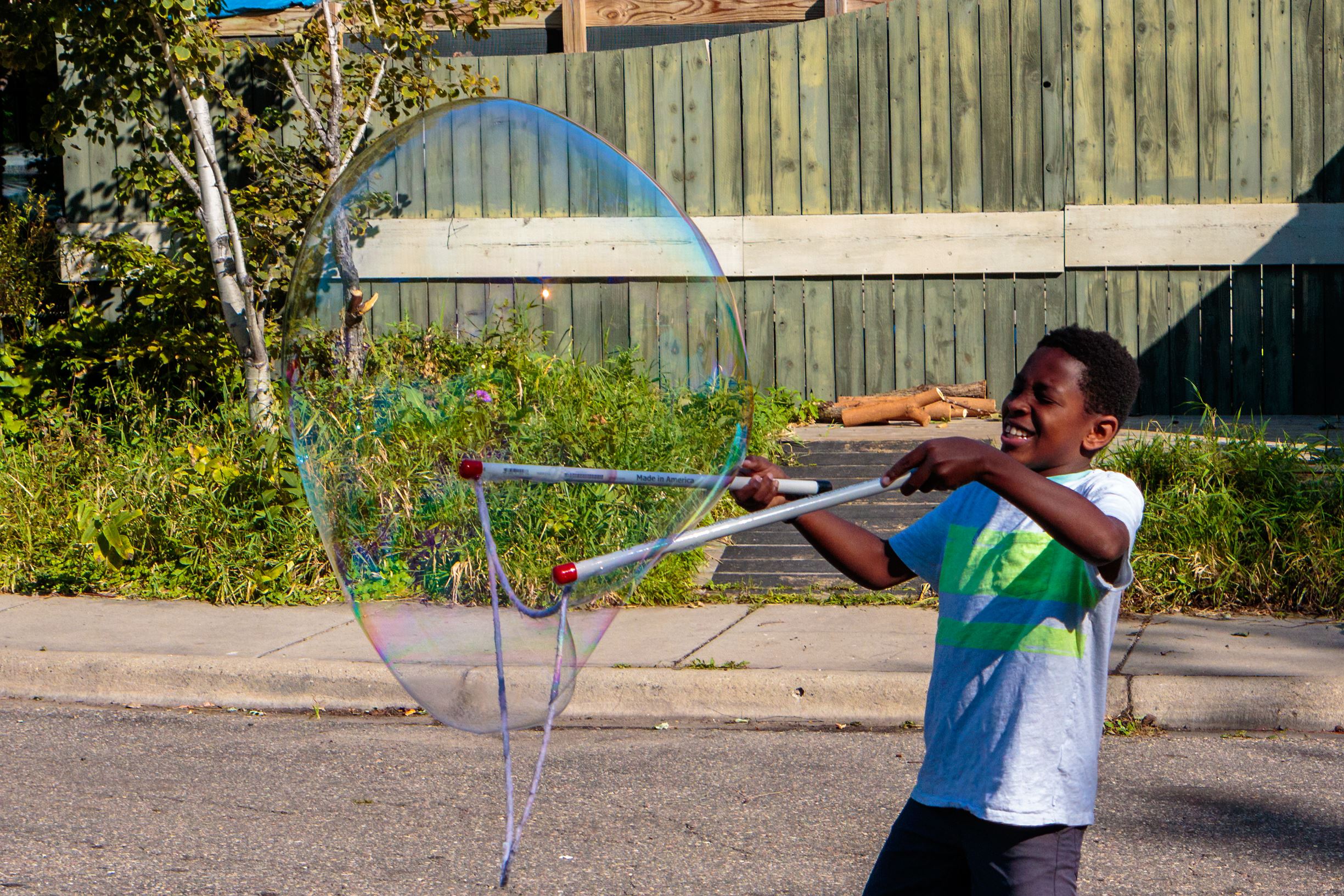 Kid blowing large bubble