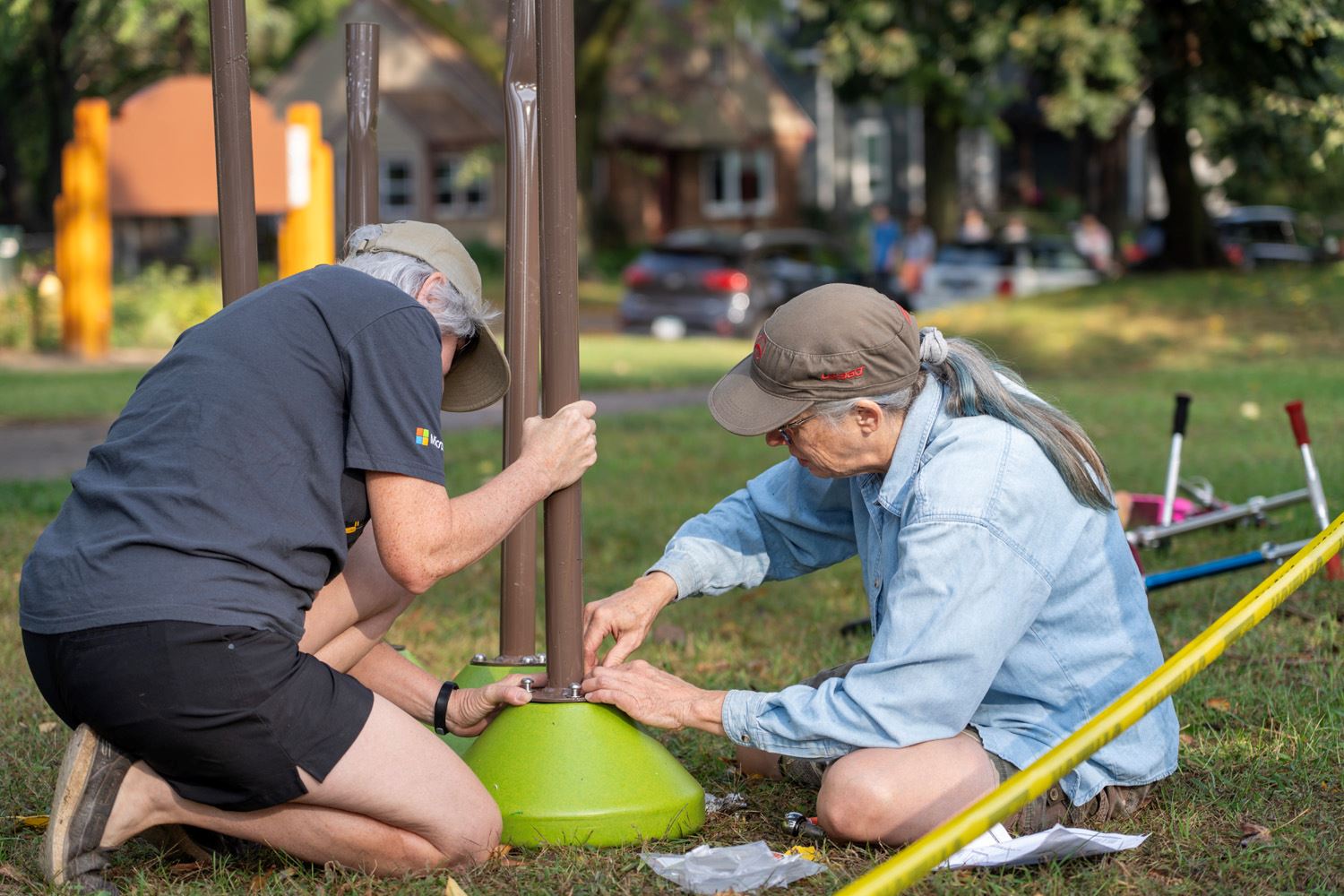 Neighborhood volunteers help build the new playground at Keya Park.