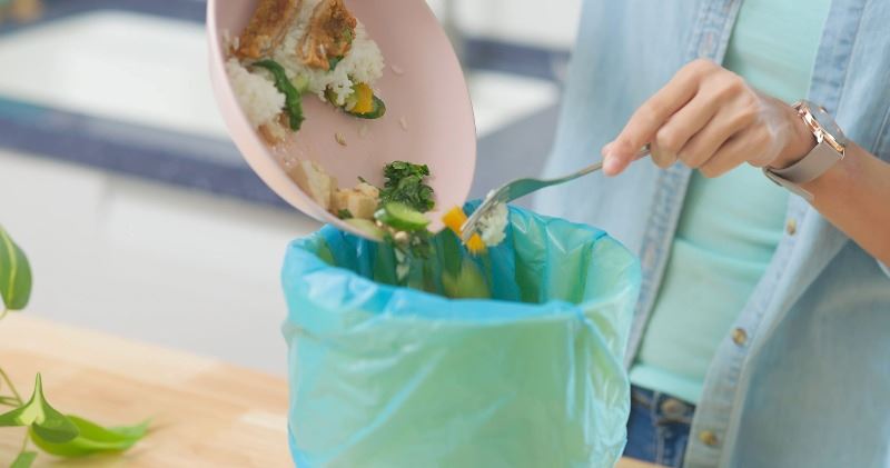 Food going into a compost bag.